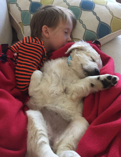 child sleeping with puppy